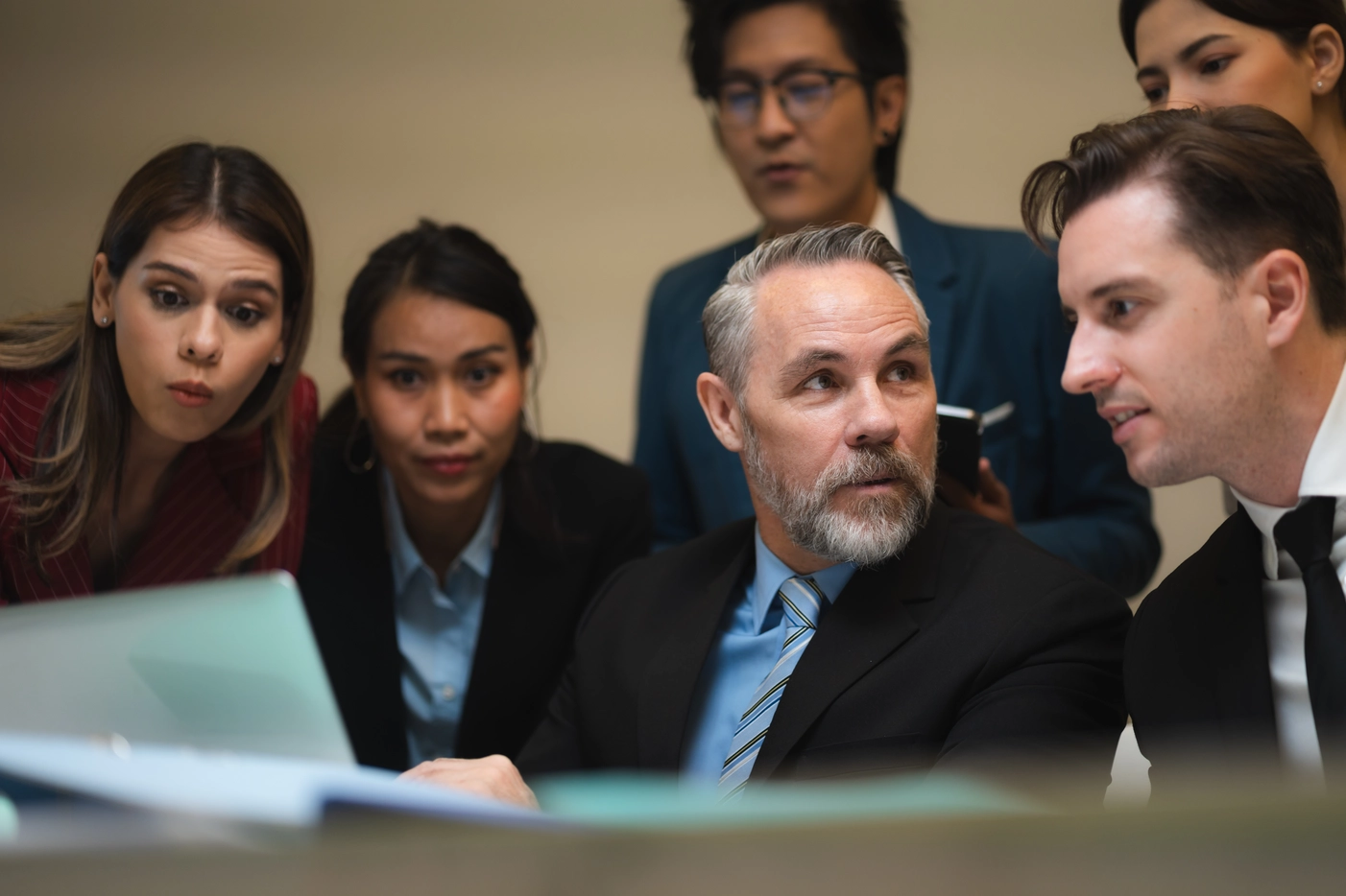 group of people looking at a computer